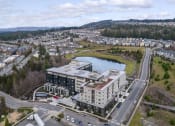 Thumbnail 45 of 48 - an aerial view of a building next to a lake