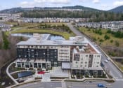 Thumbnail 10 of 48 - an aerial view of a building next to a road and a river