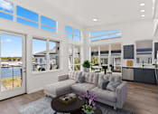 Thumbnail 6 of 30 - A modern living room with a grey sofa and a coffee table.