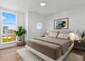 Thumbnail 9 of 30 - A bedroom with a large bed and a view of a cityscape through a window.