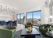 Thumbnail 19 of 30 - A modern living room with a view of the cityscape outside the large windows.