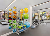Thumbnail 23 of 30 - A gym with a variety of equipment including a rowing machine, a treadmill, and a stationary bike.