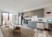 Thumbnail 6 of 32 - A modern kitchen and living room with a large window and a view of the city.
