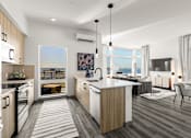 Thumbnail 2 of 32 - A modern kitchen with a large island and a view of the ocean.