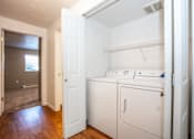 Thumbnail 3 of 12 - a laundry room with a washer and dryer and a door to a bathroom