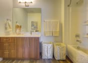 Thumbnail 30 of 35 - a bathroom with a sink and a bathtub