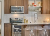 Thumbnail 32 of 35 - a kitchen with white tile and wooden cabinets