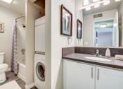 Thumbnail 11 of 26 - The Alexandar Apartments Bathroom with Washer and Dryer