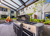 Thumbnail 24 of 28 - a stainless steel outdoor kitchen with a grill