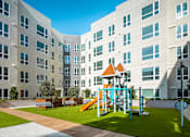 Thumbnail 21 of 34 - View at Blossom Hill San Jose affordable apartments courtyard with playground and games