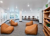 Thumbnail 5 of 34 - A room with bean bag chairs and a tree mural on the wall.