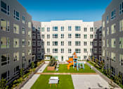 Thumbnail 22 of 34 - View at Blossom Hill San Jose affordable apartments courtyard with playground and games