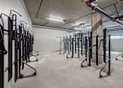 Thumbnail 28 of 34 - A gym with a row of black weight benches.