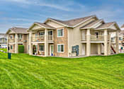 Thumbnail 13 of 13 - A large, well-maintained apartment complex with multiple buildings and green lawns.