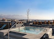 Thumbnail 21 of 22 - A hot tub on a rooftop with a view of the mountains.