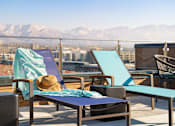 Thumbnail 20 of 22 - A sun lounger with a hat on it.