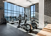 Thumbnail 15 of 22 - A gym with treadmills and exercise bikes.