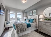 Thumbnail 4 of 39 - Lux Apartments Bellevue spacious bedroom with large windows, a queen-sized bed, side table and dresser with extra room to walk around the bed
