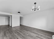 Thumbnail 7 of 10 - an empty living room with white walls and wood floors