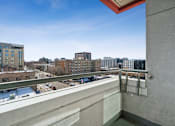 Thumbnail 13 of 20 - A balcony with a view of a cityscape and buildings.