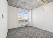 Thumbnail 20 of 20 - A room with a window and a grey carpet.