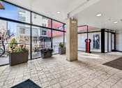 Thumbnail 1 of 20 - A large open space with a tiled floor and a pillar in the middle.