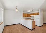 Thumbnail 15 of 21 - A kitchen with white appliances and wooden cabinets.