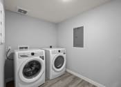 Thumbnail 12 of 30 - the living room has two washing machines and a washer and dryer