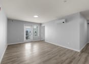 Thumbnail 10 of 30 - the living room and dining room of an empty house with white walls and wood floors