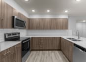 Thumbnail 15 of 30 - the preserve at ballantyne commons apartment kitchen with stainless steel appliances