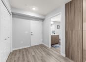 Thumbnail 17 of 30 - a hallway with a door to a bathroom and a closet