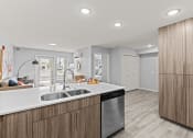 Thumbnail 2 of 30 - a kitchen with wooden cabinets and a stainless steel dishwasher