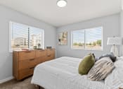 Thumbnail 6 of 30 - a bedroom with a bed and two windows