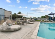 Thumbnail 23 of 30 - our apartments have a resort style pool with lounge chairs and umbrellas