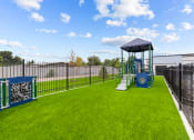 Thumbnail 28 of 30 - a playground with a swing set in the middle of a yard