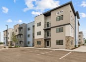 Thumbnail 29 of 30 - modern apartment buildings with a parking lot and a blue sky
