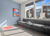 Thumbnail 4 of 21 - a living room with a couch and large windows