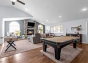Thumbnail 1 of 11 - Eagle Rock Apartments in Spokane Valley, Washington Clubhouse Lounge with Fireplace and Games