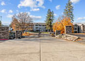 Thumbnail 6 of 11 - the gate at the conclusion of a driveway with an apartment building in the background