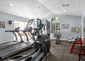Thumbnail 3 of 11 - a gym with treadmills and other exercise equipment in a room with a window