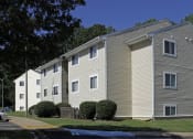 Thumbnail 2 of 5 - an apartment building with tan siding and a street