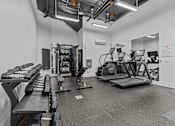 Thumbnail 3 of 22 - A gym with treadmills, exercise bikes, and other equipment.