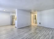 Thumbnail 5 of 26 - the living room and kitchen of an empty apartment with wood flooring