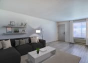 Thumbnail 6 of 26 - a living room with a black couch and a white coffee table