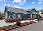 Thumbnail 42 of 44 - a blue building with pink flowers in front of it