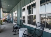 Thumbnail 38 of 44 - a porch with two chairs and a table