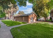 Thumbnail 8 of 15 - Curtis Apartments  brick building with a sidewalk and grass