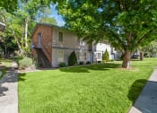 Thumbnail 6 of 15 - Curtis Apartments  lawn and trees
