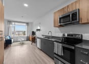 Thumbnail 1 of 20 - an apartment kitchen with stainless steel appliances and a view of the ocean