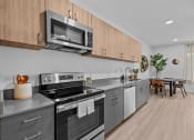 Thumbnail 2 of 20 - a kitchen with stainless steel appliances and wooden cabinets
